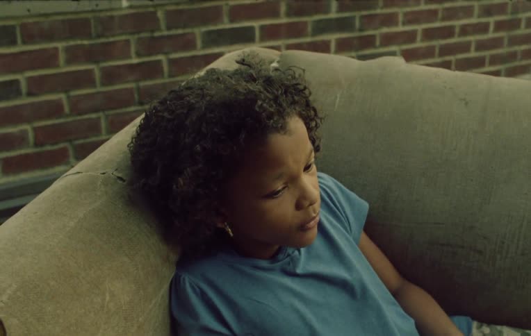 Children sit on a sofa on the roof of the building