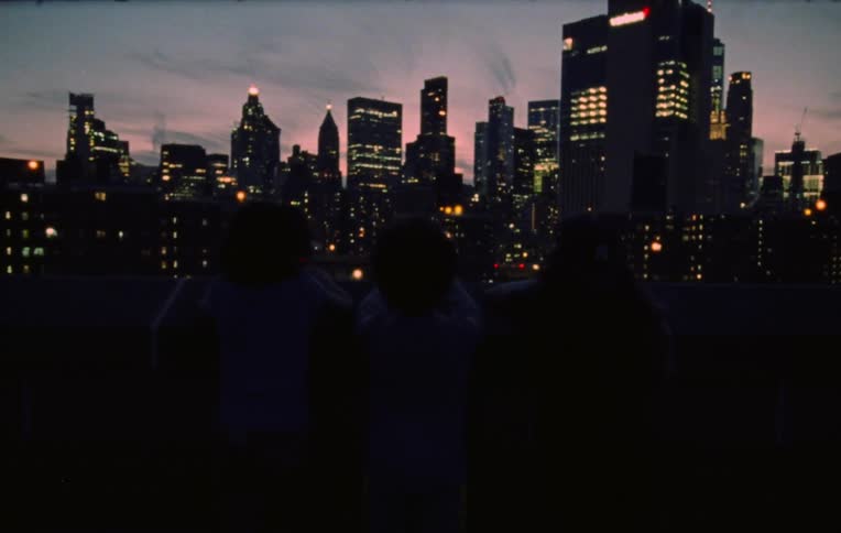 Children watching the city at dusk
