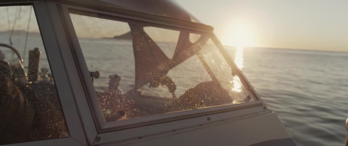 A boat is rocking in the water at sunset