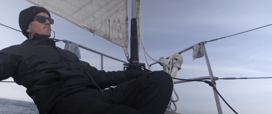 A man is sitting on a boat relaxing