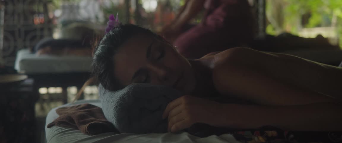 Woman lying on a spa bed with her eyes closed