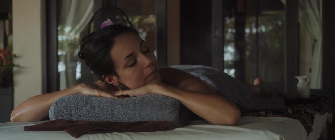 A woman is laying in the massage parlor