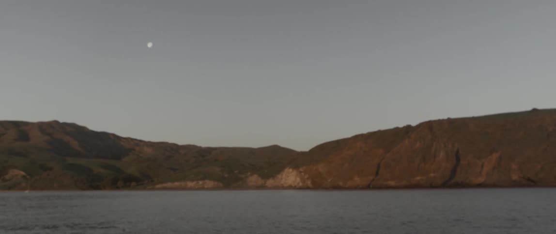 A lake leads to a mountain range ahead