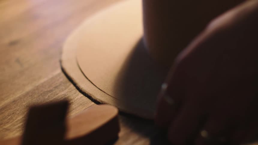 A person making a hat in a factory