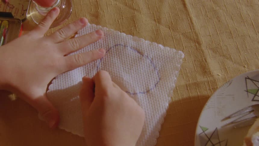 Children with colored pencils drawing on a napkin on the table