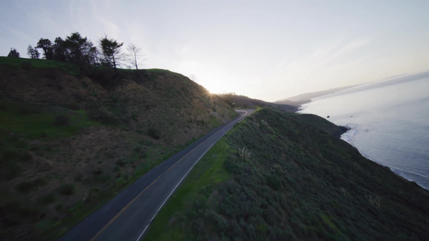 A road beside the ocean at sunrise