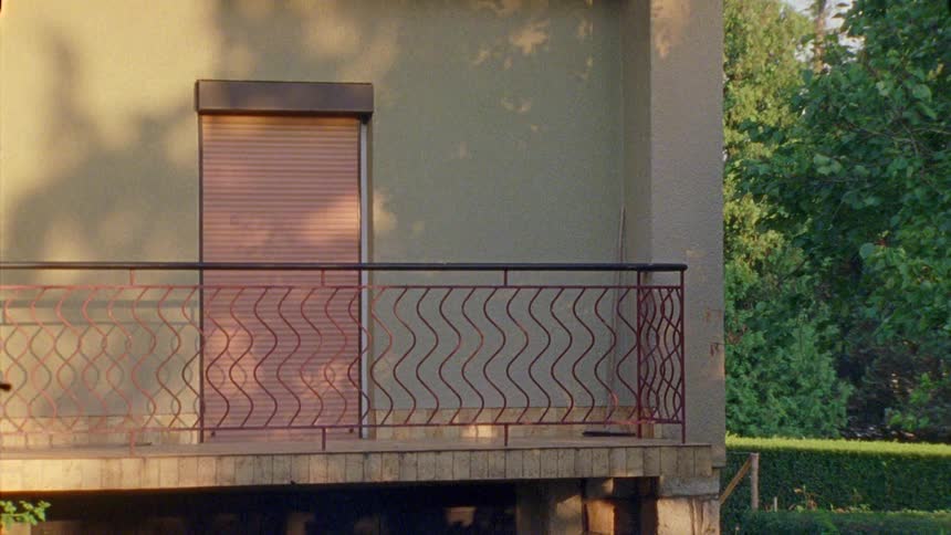 A red metallic roll up door on a balcony