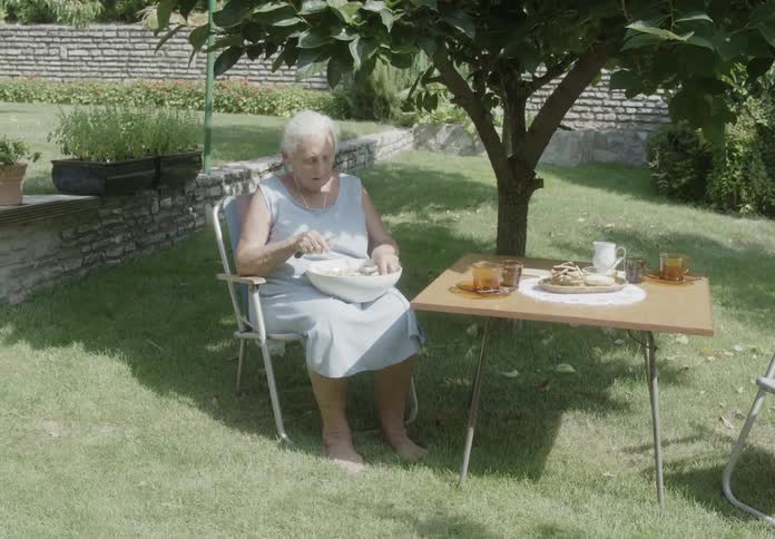A lady prepares food in her home garden