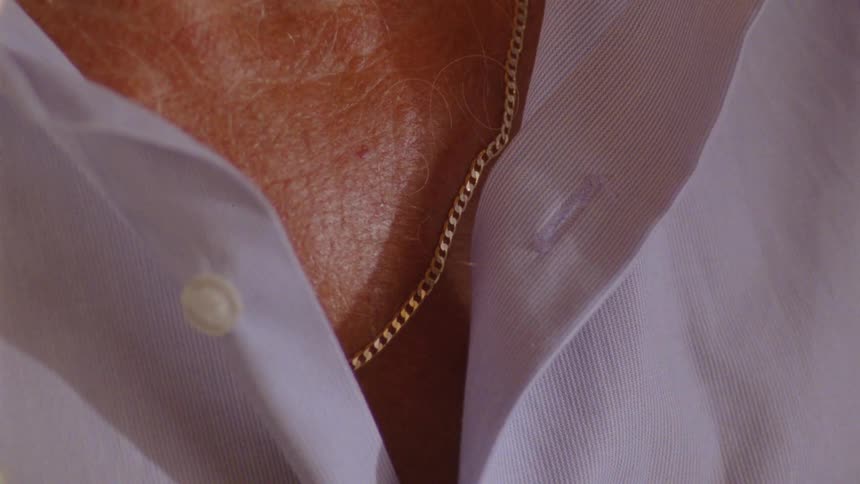 A man wears a gold chain