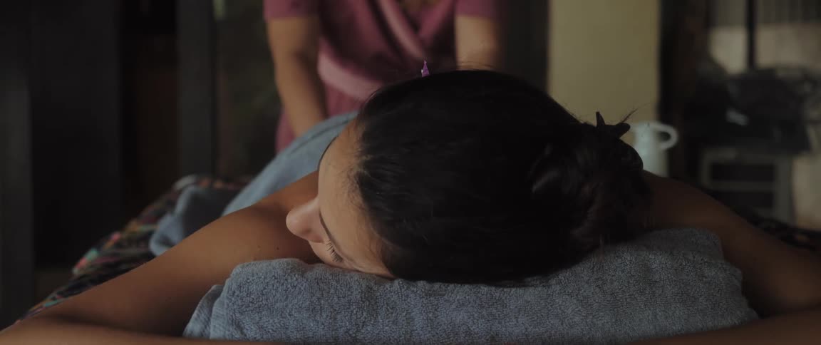 A woman is getting spa treatment at an indoor facility