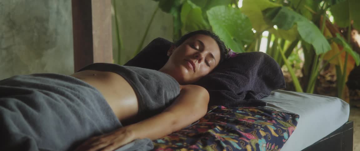 A woman sleeping relaxed in a bed