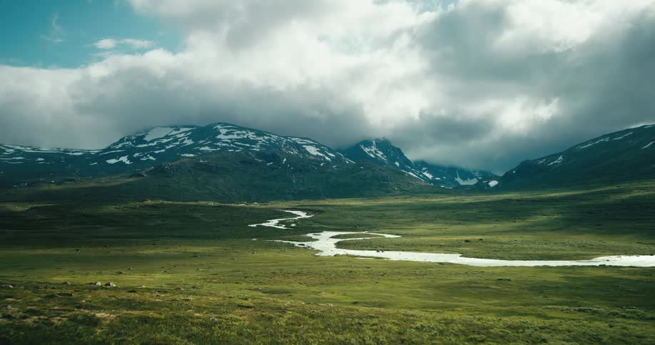 Landscape of grassland with mountains nearby