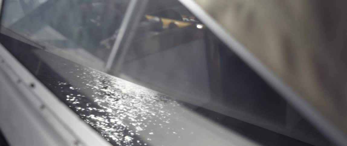 The water is reflecting on the glass of this window