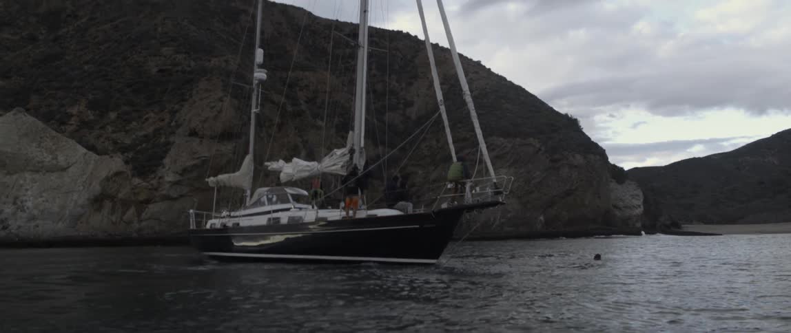 The sail on the large boat's sail is down