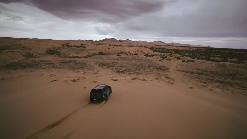 FPV drone footage of a truck racing through the desert