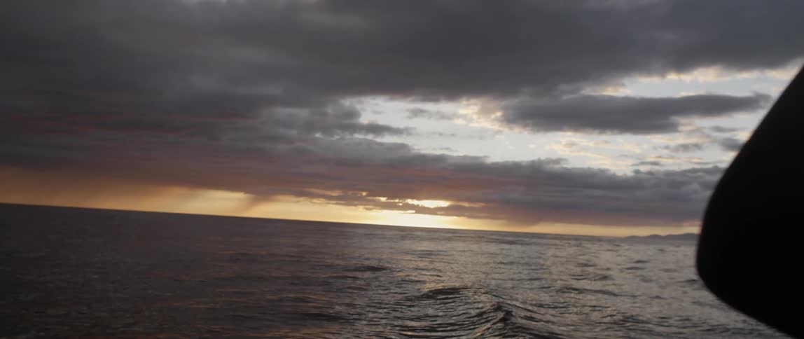 Ocean water ripples and flows at sunset