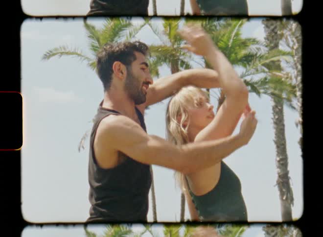 A man and woman are dancing outdoors together
