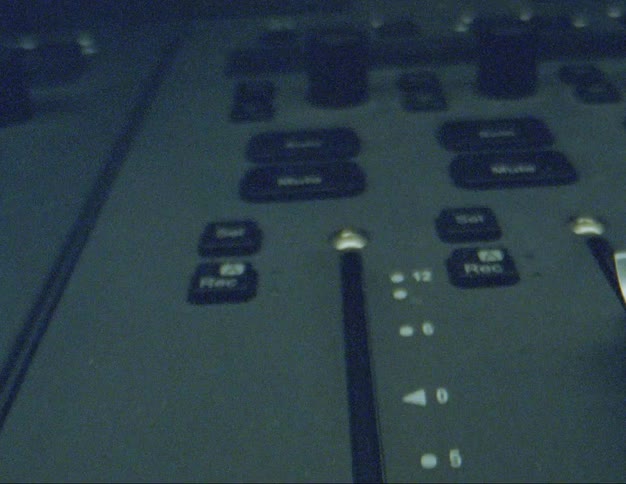 Extreme closeup of a finger lifting a small lever on a device