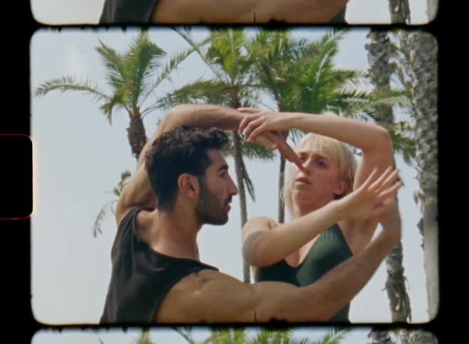 A man and a woman dancing using their arms