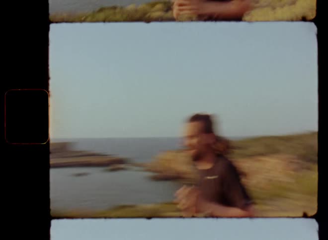 Man in black shorts and shirt wearing sports apparel stands on a trail overlooking the ocean and breathing heavily before he starts running or jogging up the hill to achieve his fitness and health goals training for a marathon or race on Super-8