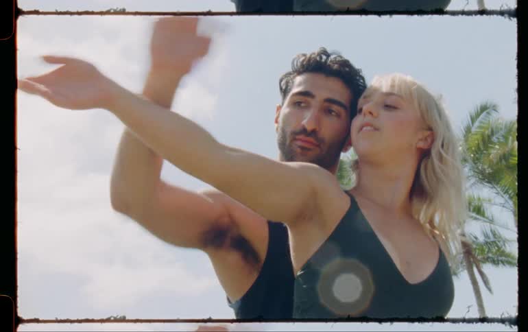 A couple of dancers dancing outdoors