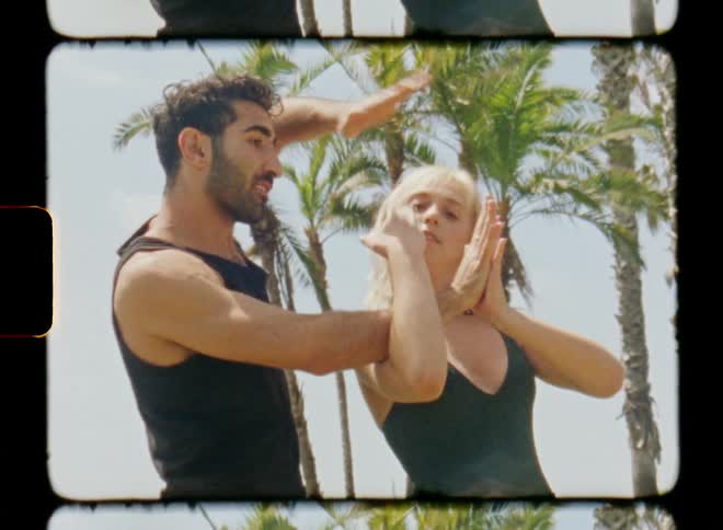 Woman and man dancing together outdoors in a tropical area