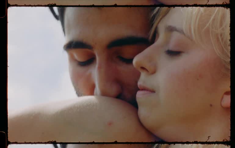 Man and woman are dancing outdoors together in the summer