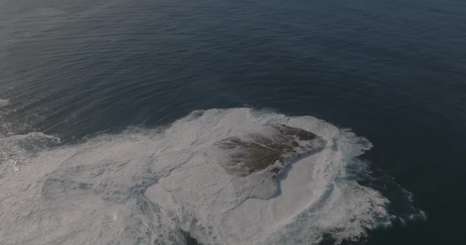 The ocean water covers the rock