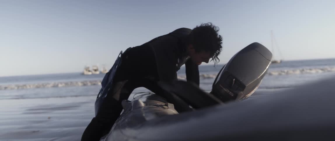 A man is digging around in a raft