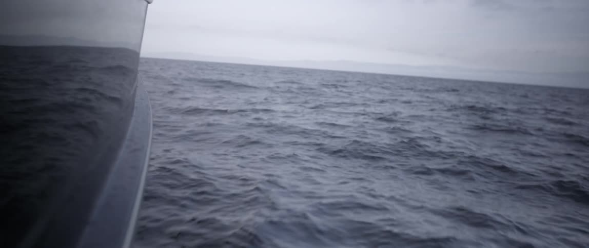 A boat is sailing in the water fast