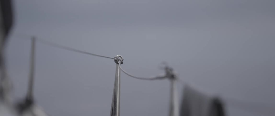 The railing on the side of a boat shows water ahead