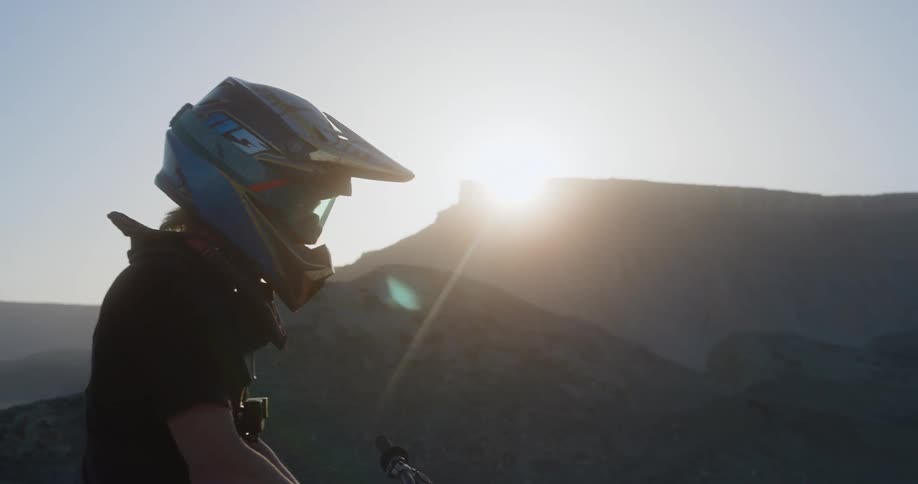 A motorcyclist pauses to examine their surroundings