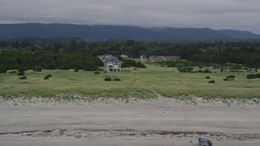 Aerial view of houses surrounded by green fields near the beach in Long Beach Washington during the summer