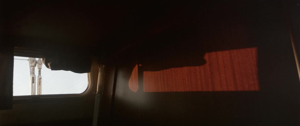 A dark room has a single window