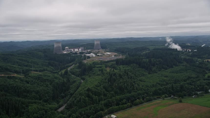 Aerial footage of Satsop Nuclear Power Plant in Satsop Washington surrounded by forest showcasing power generation and the plant's impact on the environment