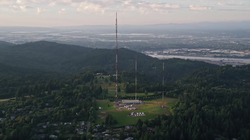  aerial footage of sunset over hilltop radio towers in Southwest Portland Oregon showcasing the picturesque views of the city skyline and surrounding natural landscape