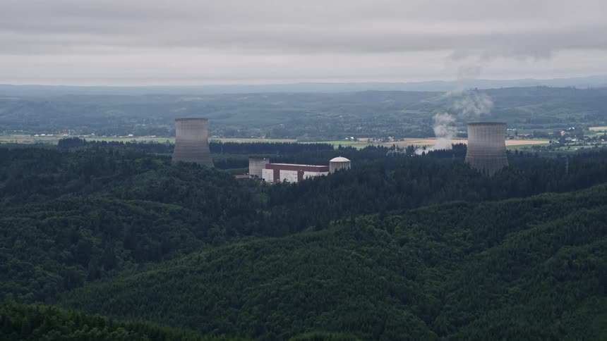 Aerial view of Satsop Nuclear Power Plant cooling towers surrounded by forest in Satsop Washington on an overcast day during summer
