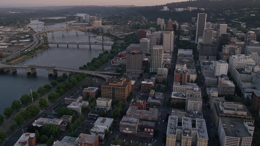 Approaching US Bancorp Tower and bridges over the Willamette River during sunset in downtown Portland Oregon