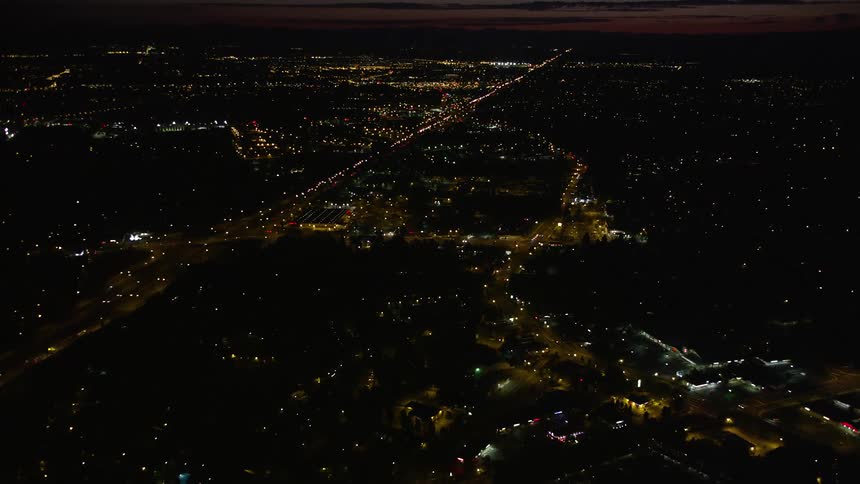 Aerial view of Home Depot and Highway 26 in Southwest Portland Oregon at night with partly cloudy skies and light traffic