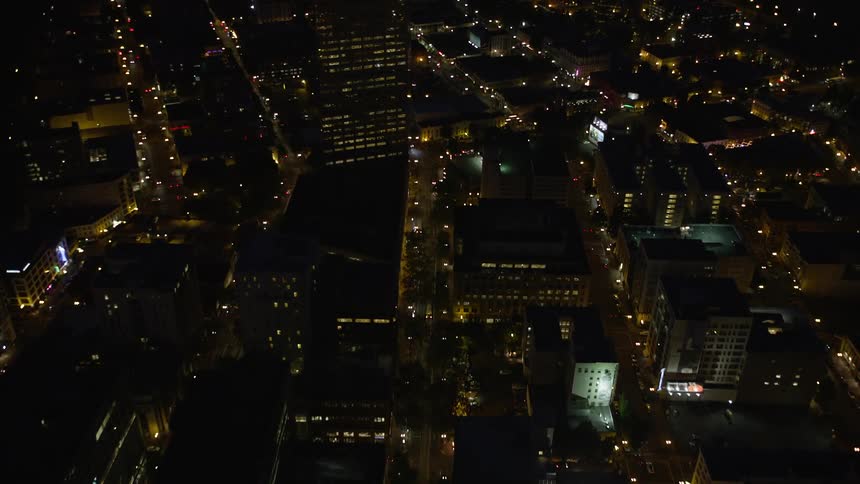 5th Avenue flyover reveals US Bancorp Tower and Broadway Bridge city lights illuminate downtown Portland's metropolis at night