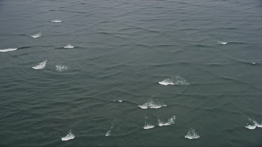Aerial view of rolling waves on the Columbia River near Cape Disappointment Washington on a summer day in the Pacific Northwest