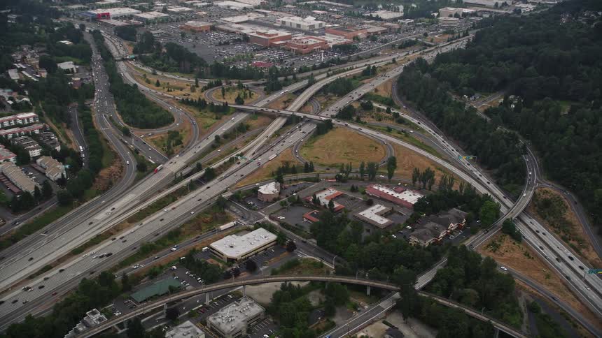 Aerial view of office buildings and the I-405 / I-5 interchange in Tukwila WA with light traffic running through the roads during a sunny summer day in Washington