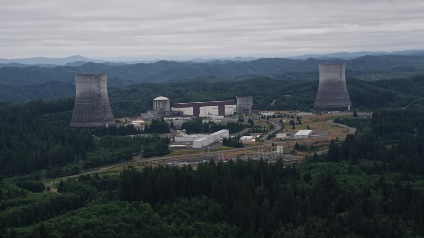 Aerial footage of the Satsop Nuclear Power Plant in Satsop Washington showcasing the industrial facility located in a forested environment