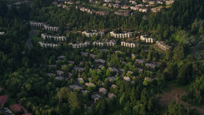 Aerial view of hillside apartment buildings in Southwest Portland at sunset showcasing the cityscape amidst nature in the Pacific Northwest