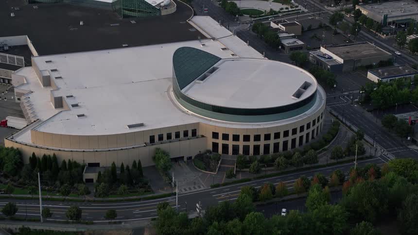 Aerial footage of approaching office buildings Oregon Convention Center and Lloyd Center in Northeast Portland Oregon during sunset