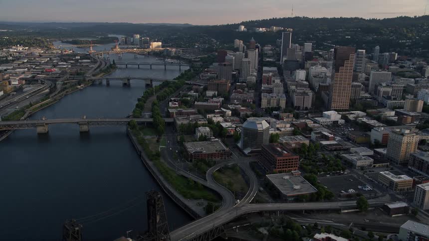 Aerial view of city bridges spanning the Willamette River at sunset showcasing the downtown area with its skyscrapers transportation and city river