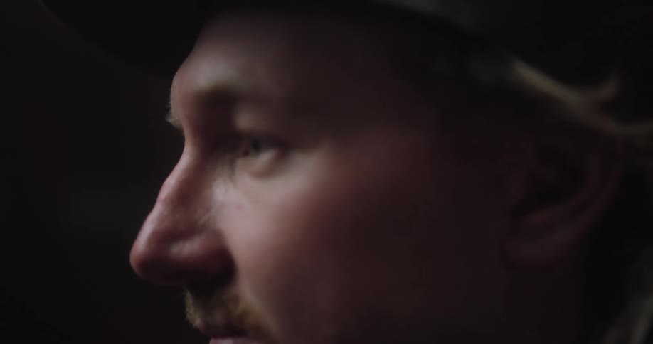 Side profile of blonde man with beard and sunhat