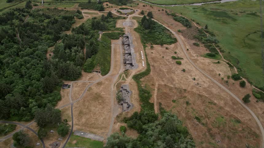 Fly over the historic Fort Stevens in Oregon a famous landmark of the Pacific Northwest during a daytime aerial shoot in the summer