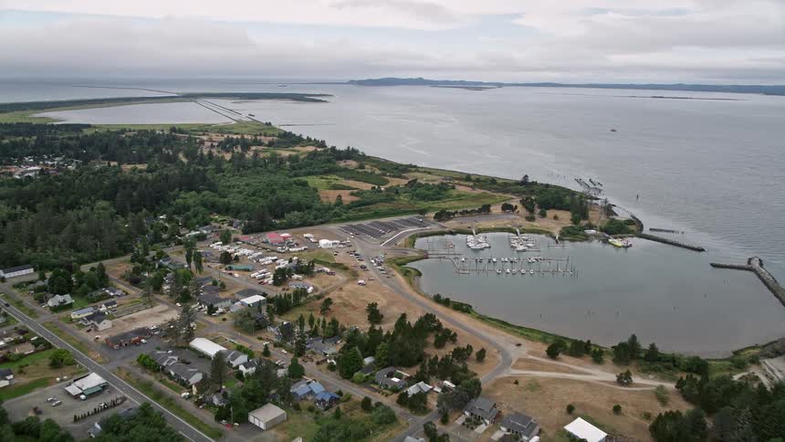  aerial footage capturing the scenic views of residential neighborhoods a marina and an RV park in Warrenton Oregon along the Columbia River showcasing the natural beauty of the Pacific Northwest during a sunny summer day