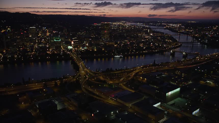 an aerial view of downtown Portland Oregon at twilight showcasing the majestic skyscrapers the Morrison Bridge and the Burnside Street Bridge